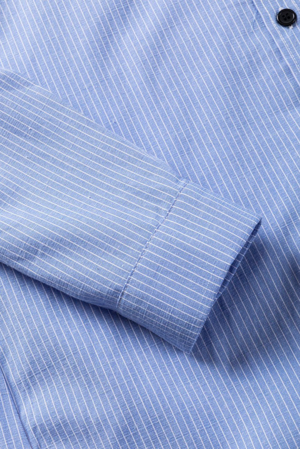 Sky blue stripe long shirt with roll-tab sleeves and front pockets by ModestAndDevoted, made from polyester and cotton blend.