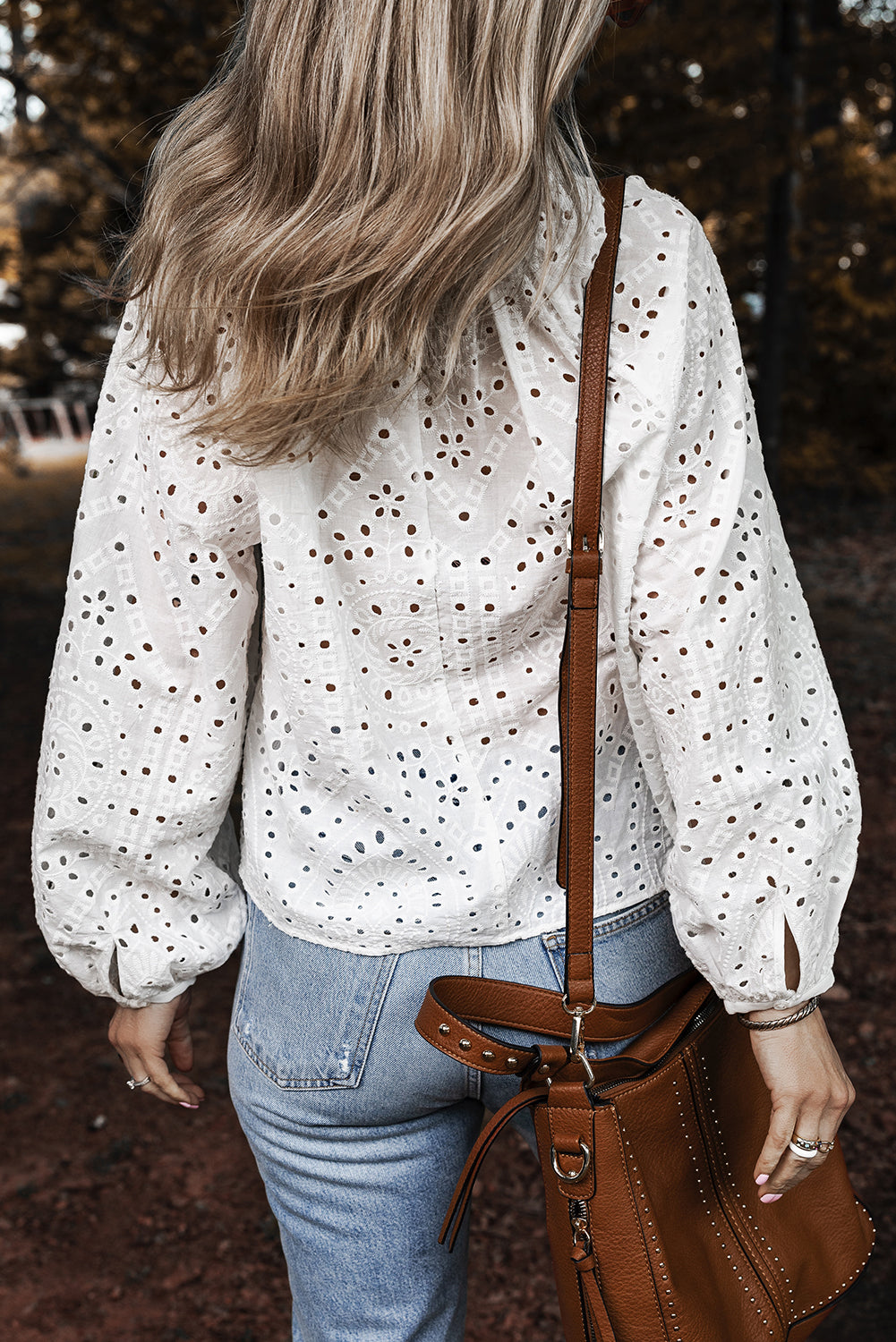 White eyelet embroidered puff sleeve V-neck blouse from ModestAndDevoted, featuring cotton fabric and delicate embroidery details.