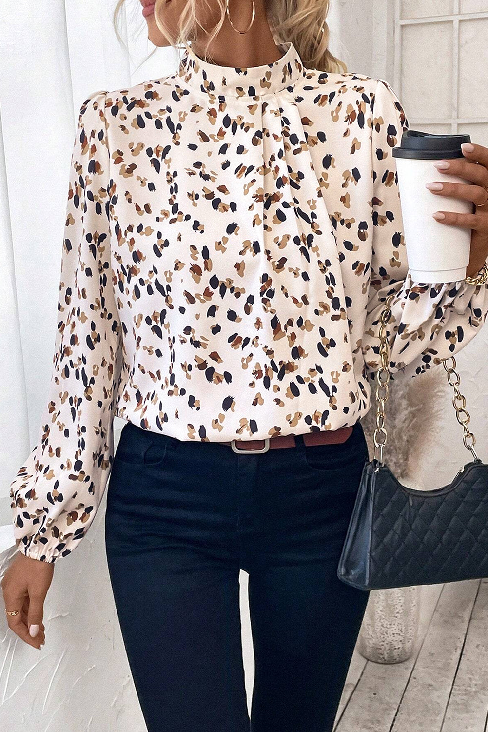 White leopard print lantern sleeve mock neck blouse from ModestAndDevoted, featuring pleated fabric and stylish design.