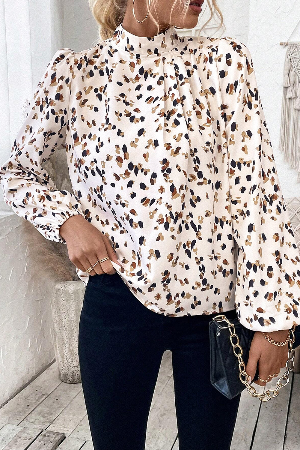 White leopard print lantern sleeve mock neck blouse with pleats from ModestAndDevoted, featuring a stylish and elegant design.