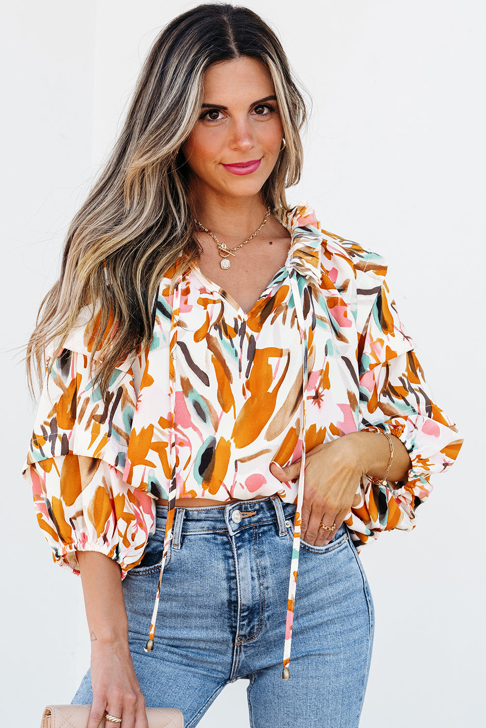 Yellow abstract print blouse with drawstring, frilled V-neck, 3/4 sleeves, from ModestAndDevoted, made of lightweight polyester fabric.