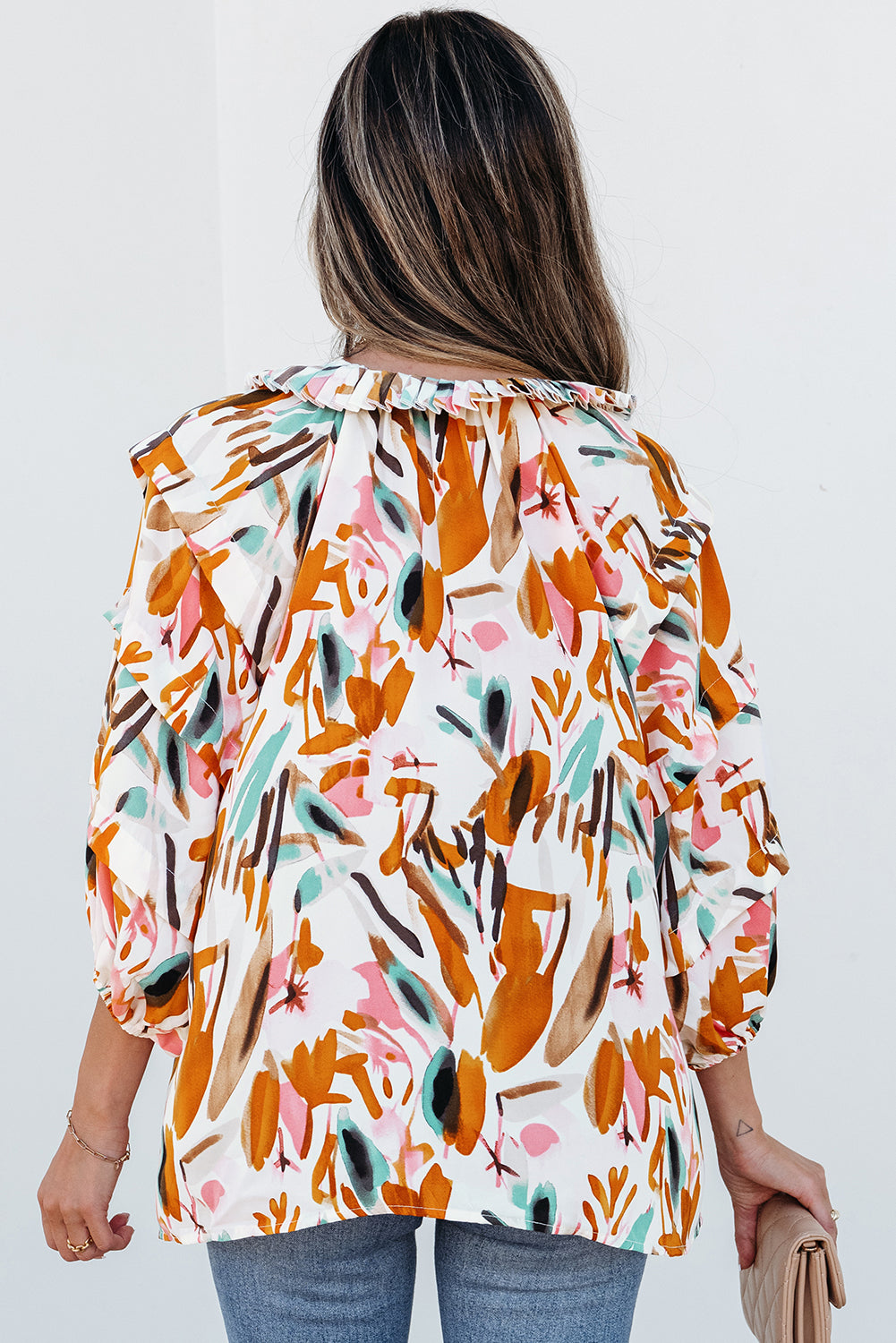 Yellow abstract print blouse by ModestAndDevoted featuring a V-neck, drawstring detail, frilled edges, and 3/4 sleeves.