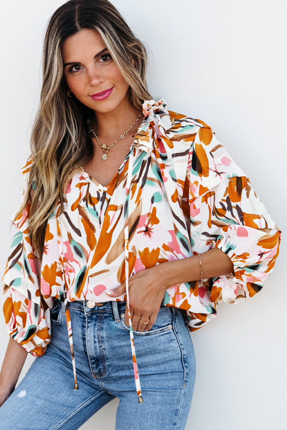 Yellow abstract print blouse with V-neck, drawstring, frilled details, and 3/4 sleeves from ModestAndDevoted, made of polyester.