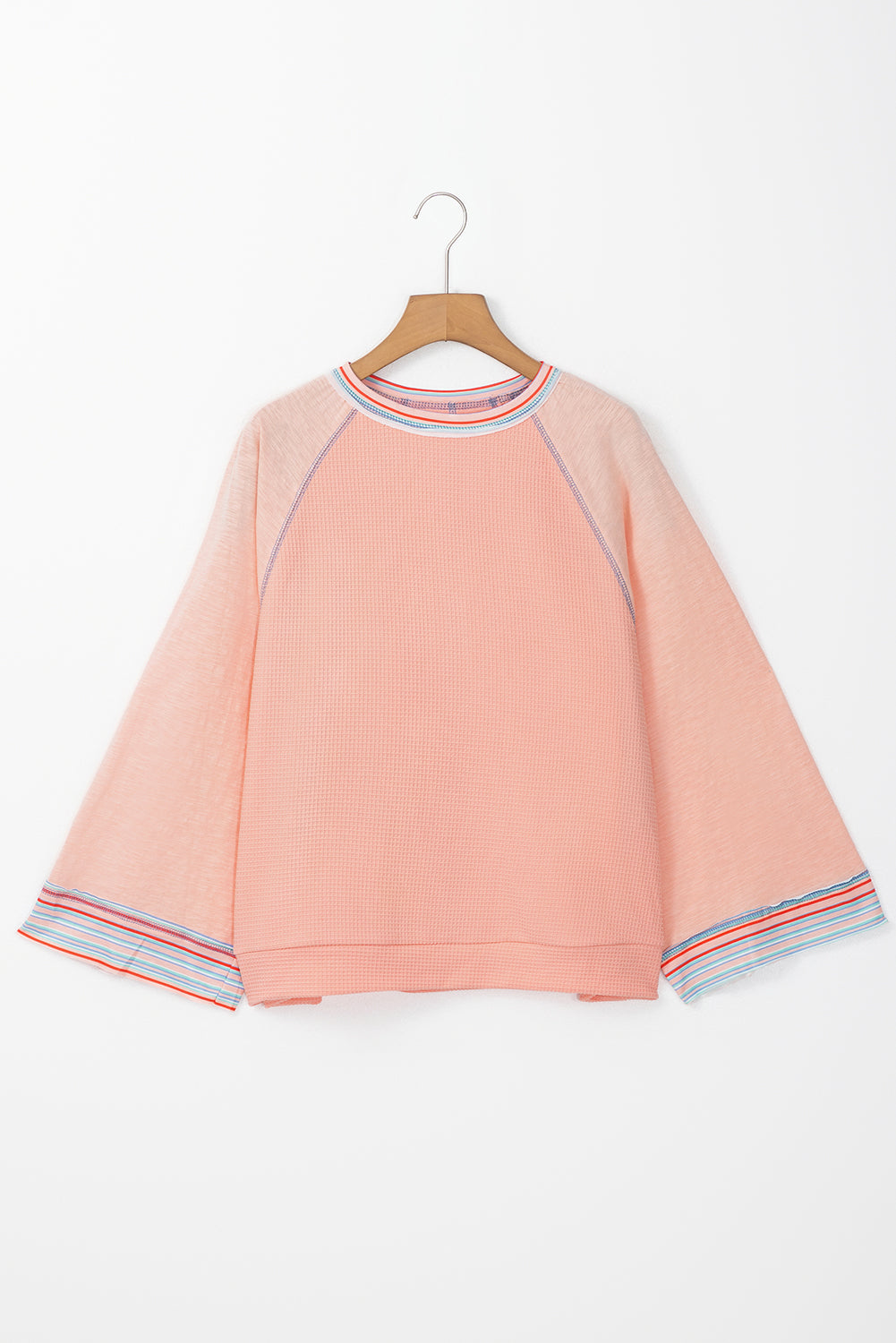 ModestAndDevoted grapefruit orange waffle knit raglan top with wide bracelet sleeves and patchwork design, long sleeve blouse.