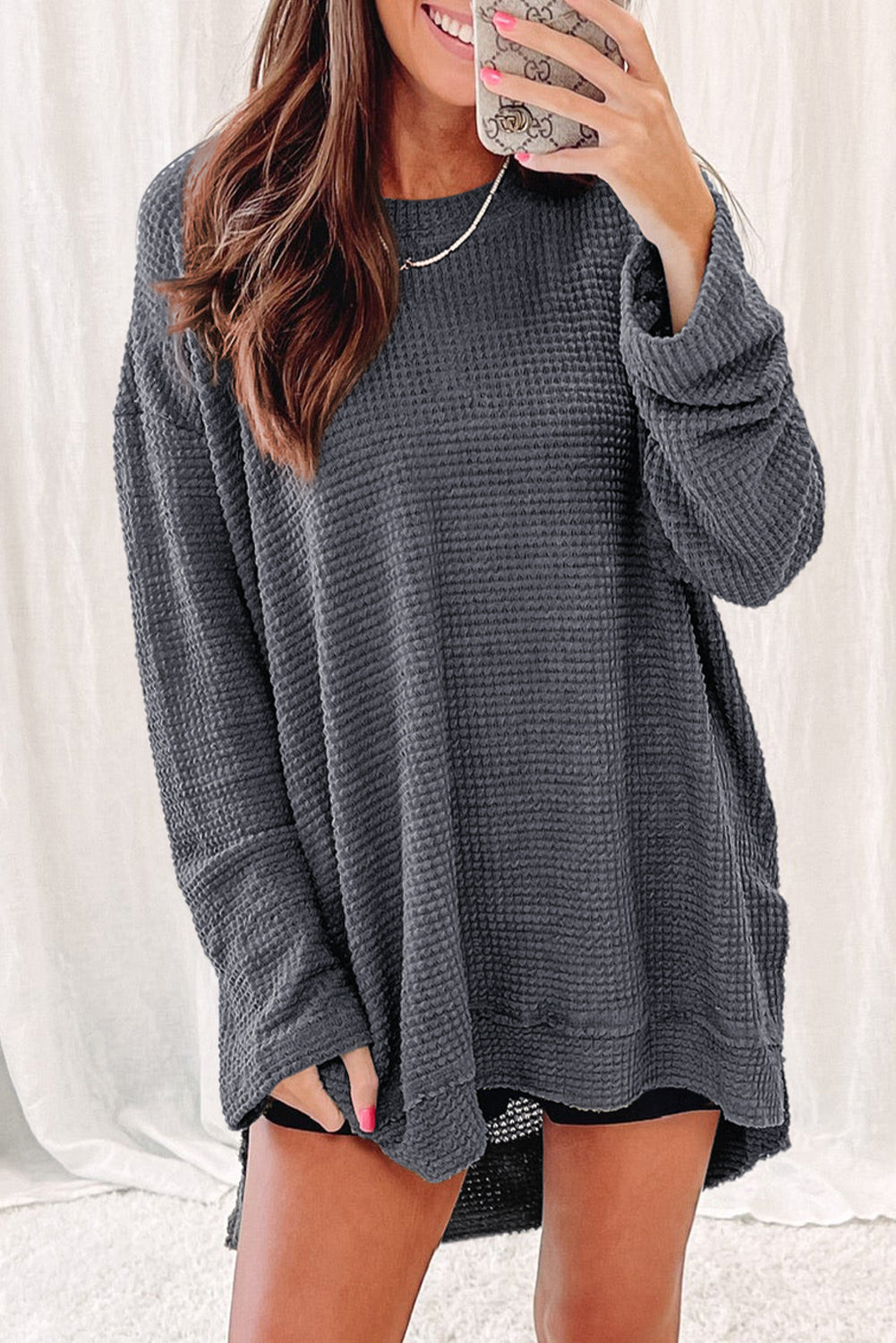 Gray waffle knit oversized long sleeve top with high slits from ModestAndDevoted, made of polyester and elastane fabric.
