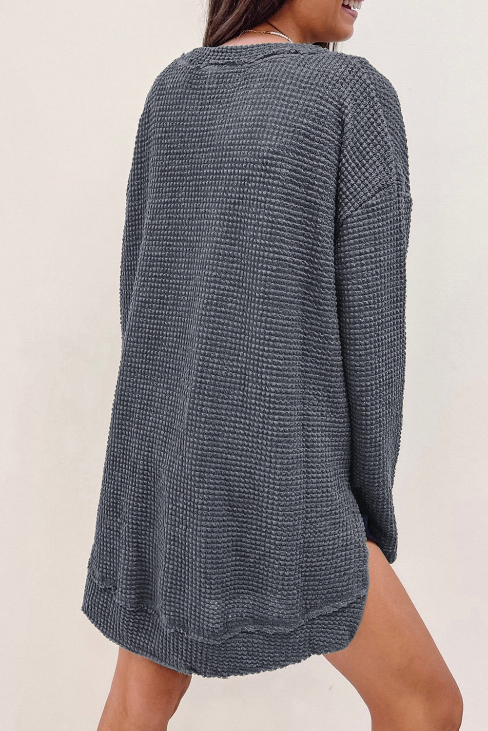 Gray waffle knit oversized top with high slits from ModestAndDevoted, long sleeve design, made of polyester and elastane.