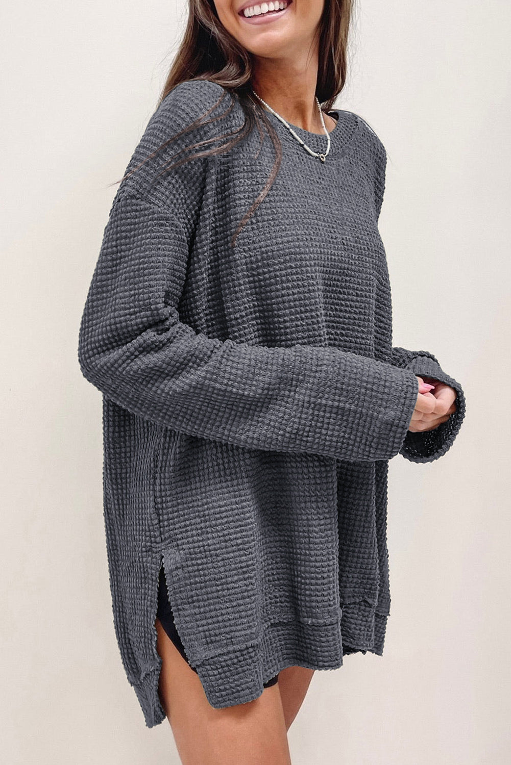 Gray waffle knit oversized long sleeve top with high slits from ModestAndDevoted, featuring a relaxed fit and textured fabric.