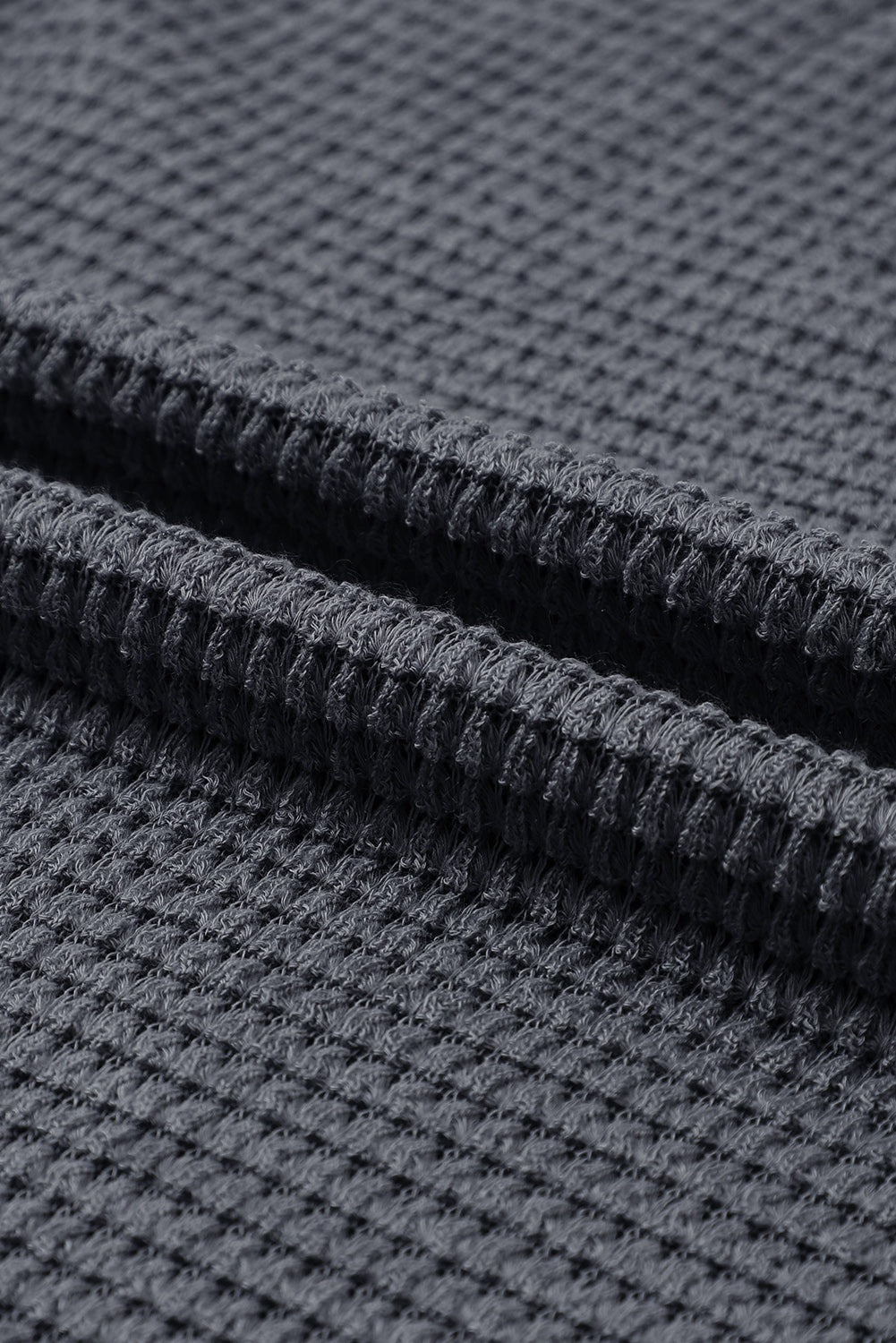 Gray waffle knit oversized top with high slits, long sleeve design from ModestAndDevoted, made of polyester and elastane fabric.