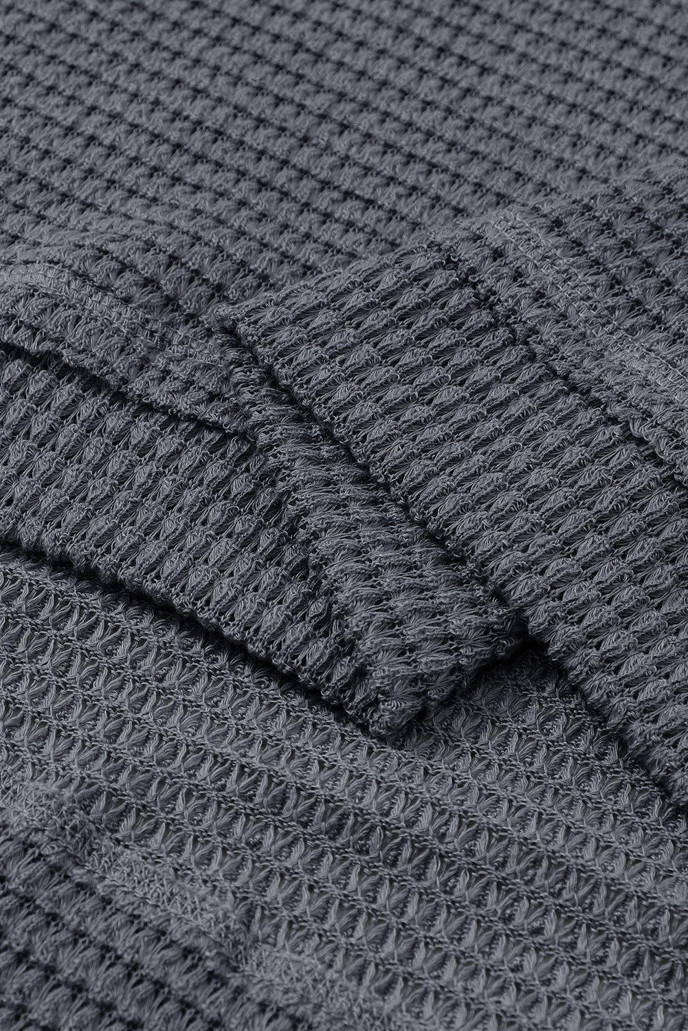 Gray waffle knit oversized long sleeve top with high slits from ModestAndDevoted, featuring a relaxed fit and textured fabric.
