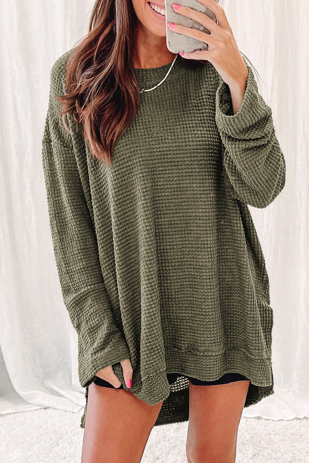 Green waffle knit oversized long sleeve top with high slits from ModestAndDevoted, featuring a relaxed fit and textured fabric.