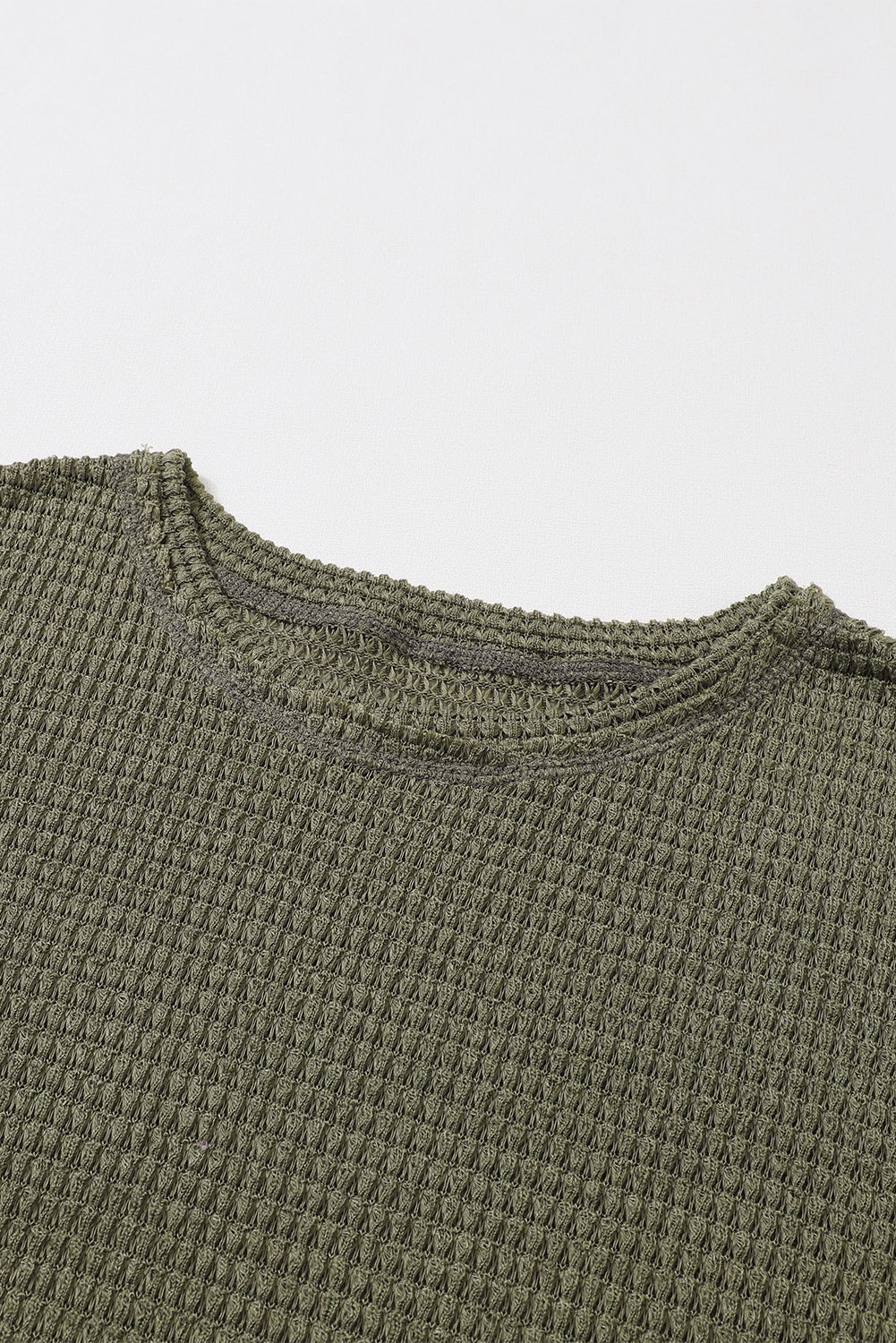 Green waffle knit oversized long sleeve top with high slits from ModestAndDevoted, featuring a relaxed fit and textured fabric.