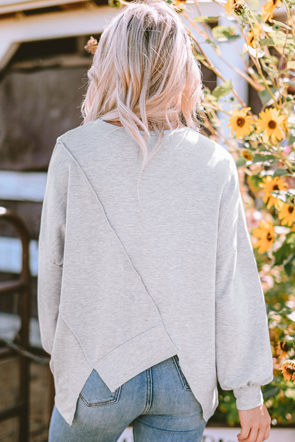 Rose pink long sleeve top with colorblock stitching and irregular hem by ModestAndDevoted, made of polyester, cotton, and elastane.