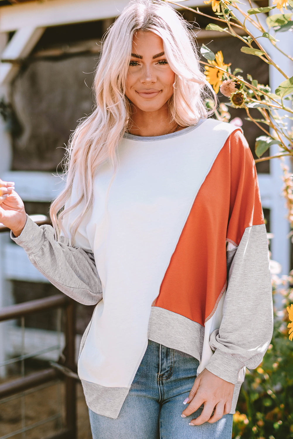 Rose pink long sleeve top with colorblock stitching and irregular hem from ModestAndDevoted, made of polyester, cotton, and elastane.