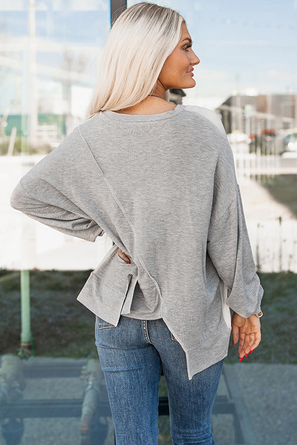 Rose pink long sleeve top by ModestAndDevoted with colorblock stitching and irregular hem, made of polyester, cotton, and elastane.