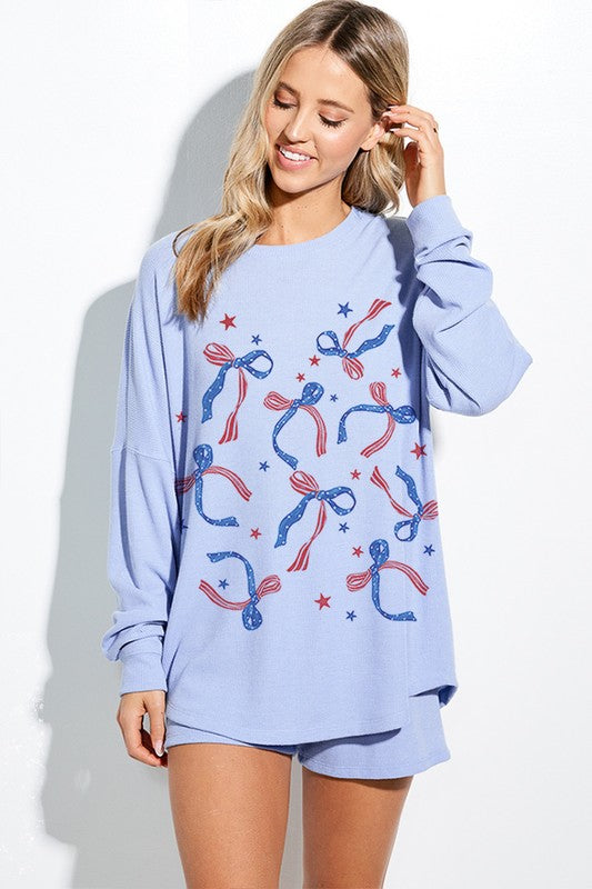 Blue patriotic bow long sleeve top by ModestAndDevoted, featuring a comfortable fit and stylish design.