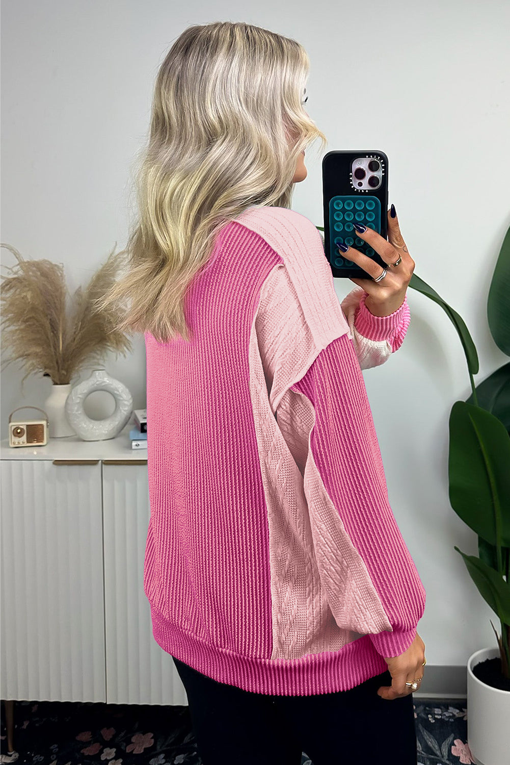ModestAndDevoted Bonbon cable knit colorblock sweatshirt with exposed seams, featuring a stylish and cozy design in soft knit fabric.