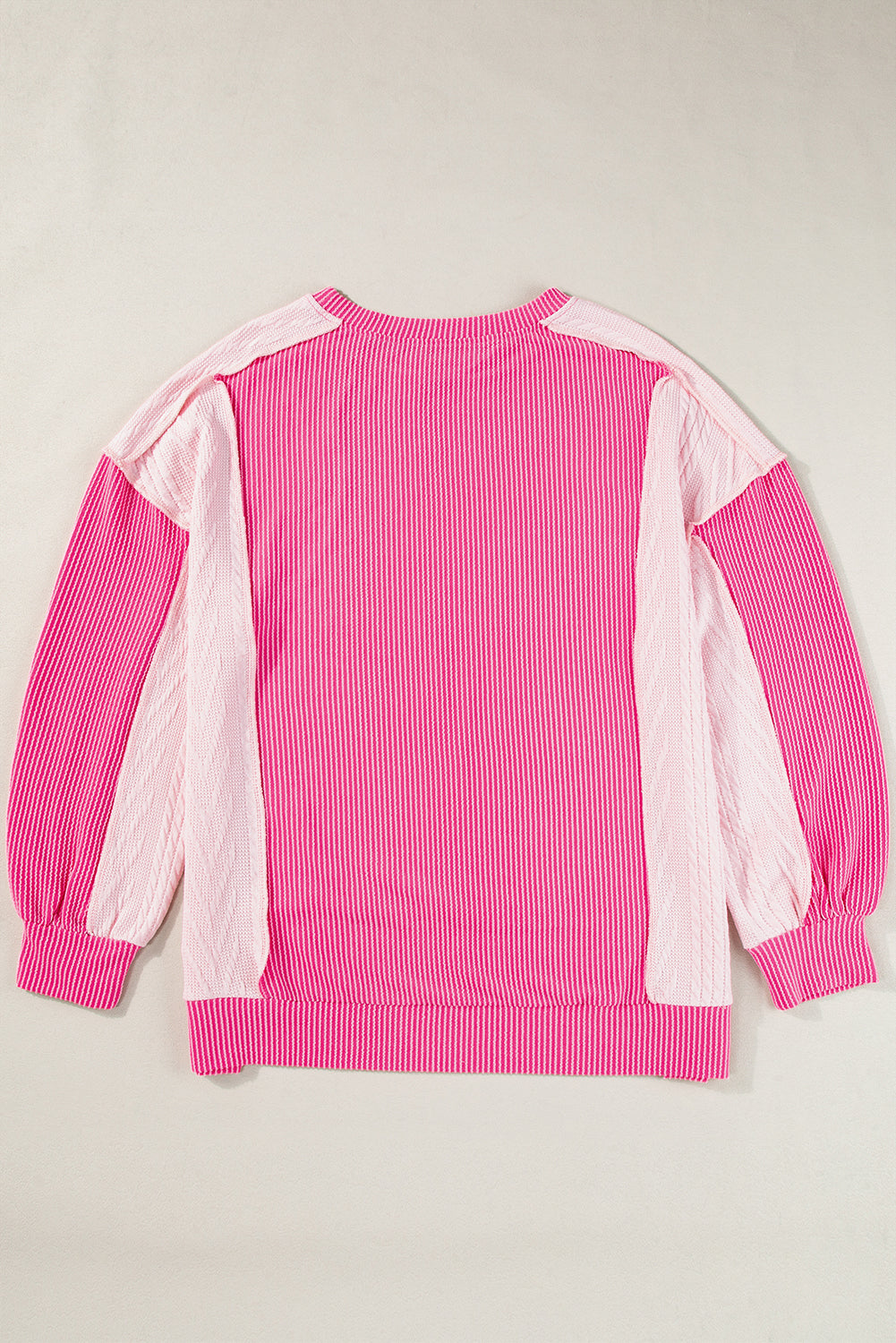 ModestAndDevoted Bonbon cable knit colorblock sweatshirt with exposed seams, featuring a cozy, stylish design in mixed fabric textures.