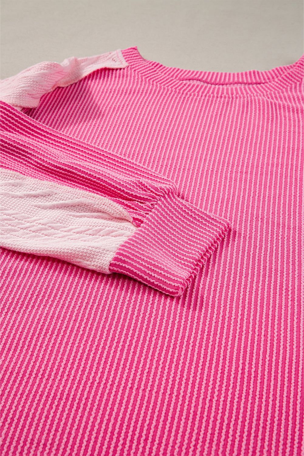 ModestAndDevoted Bonbon cable knit colorblock sweatshirt with exposed seams, featuring a cozy, stylish design in soft fabric blend.