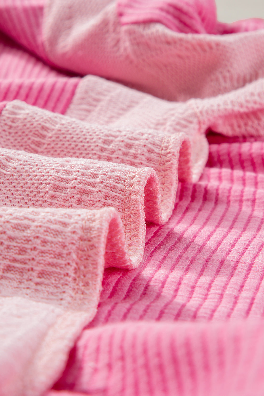 ModestAndDevoted Bonbon cable knit colorblock sweatshirt with exposed seams, featuring a cozy, stylish knit design in vibrant colors.