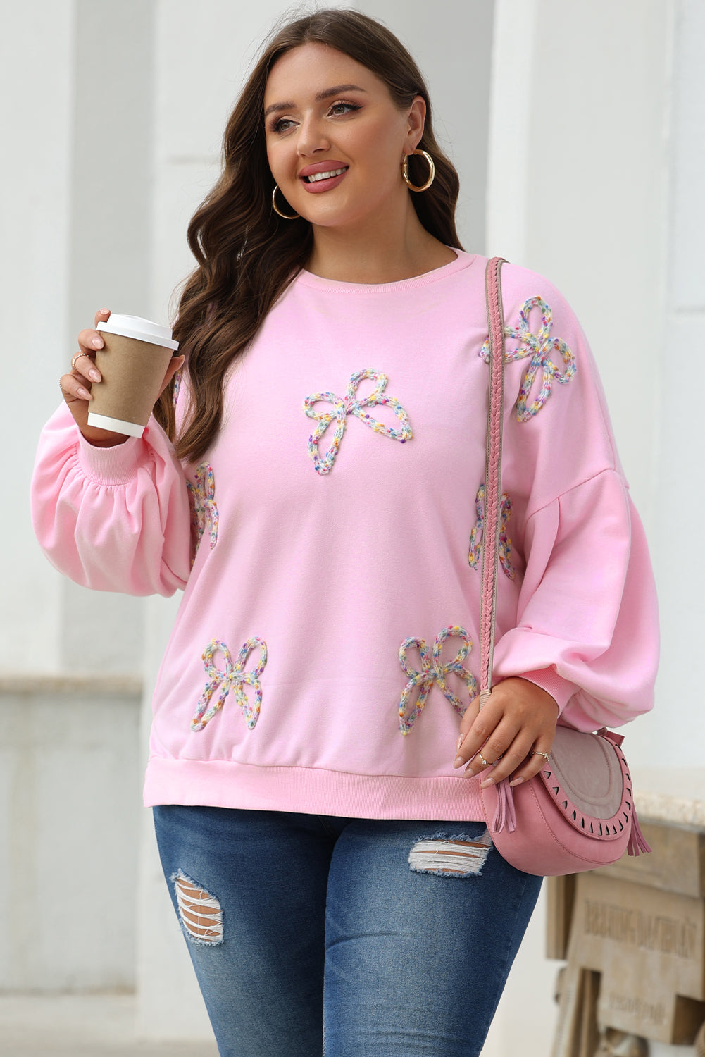 Light pink embroidered bow lantern sleeve oversized sweatshirt from ModestAndDevoted, featuring a cozy, stylish pullover design.