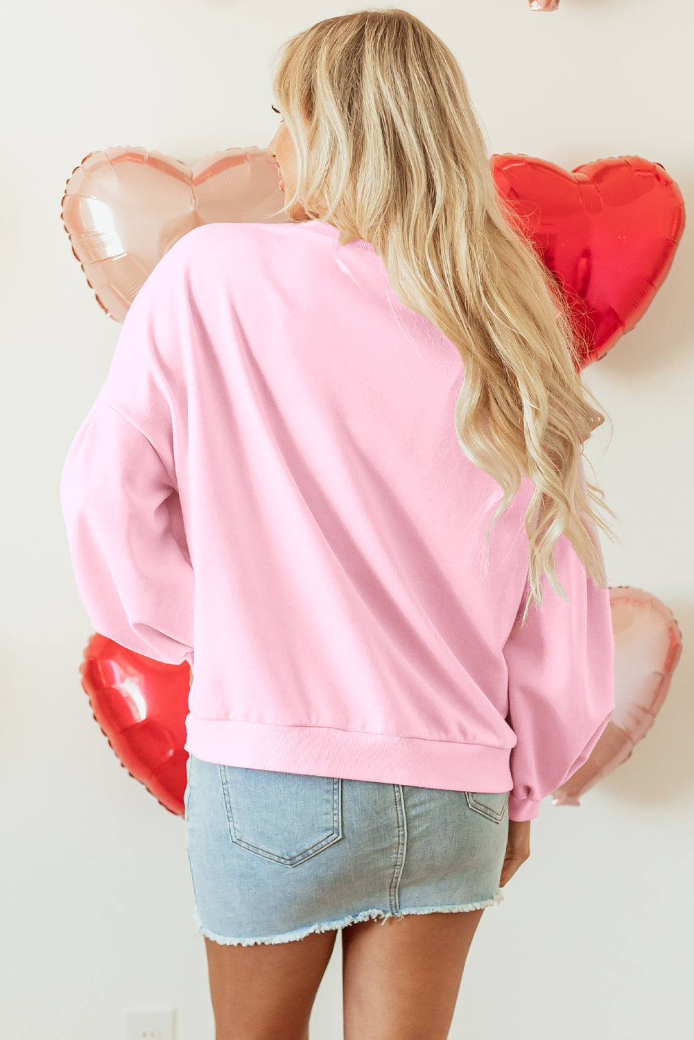 Light pink embroidered bow lantern sleeve oversized sweatshirt from ModestAndDevoted, featuring a cozy pullover design and relaxed fit.