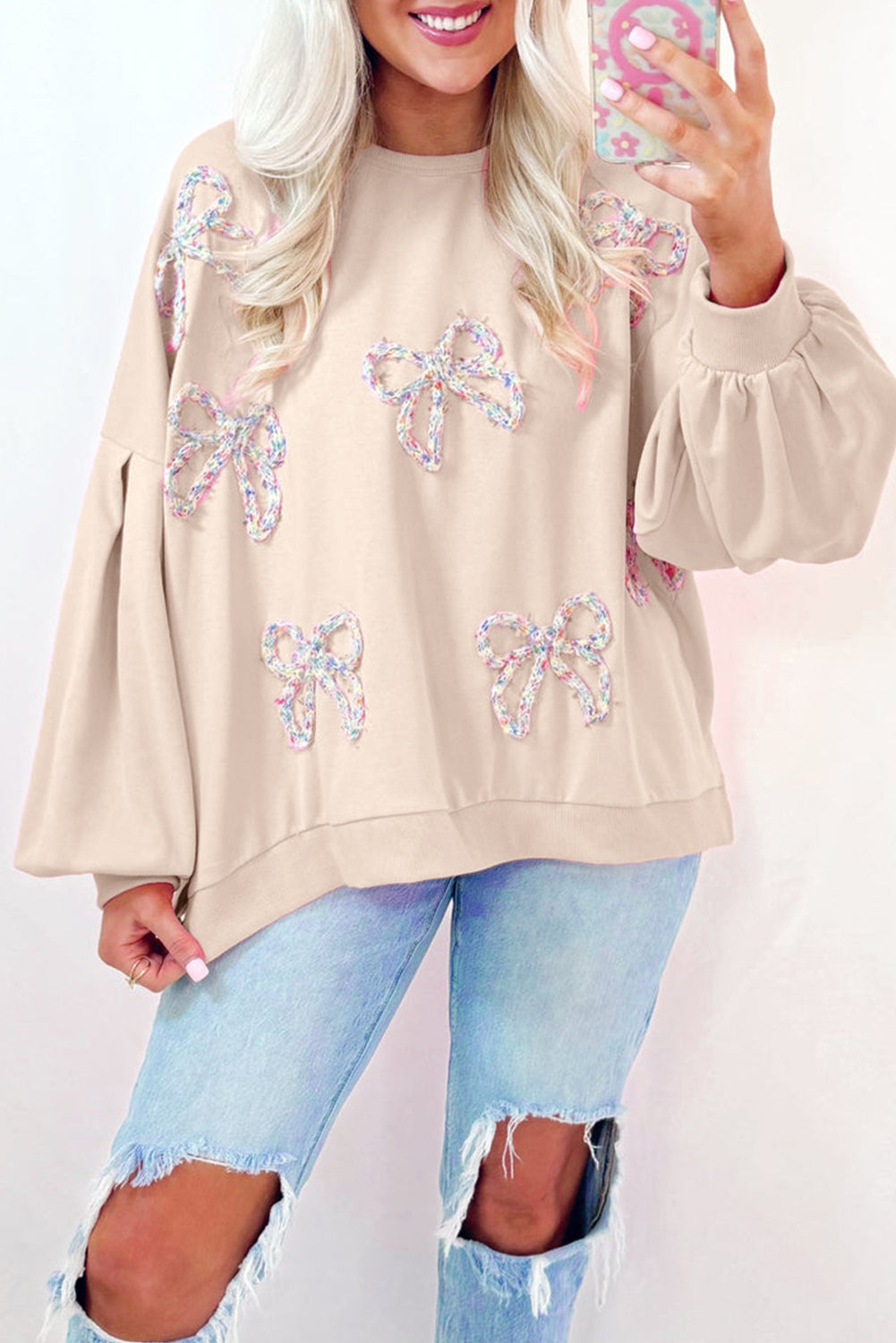 Light pink embroidered bow lantern sleeve oversized sweatshirt by ModestAndDevoted, featuring a cozy pullover design with stylish details.