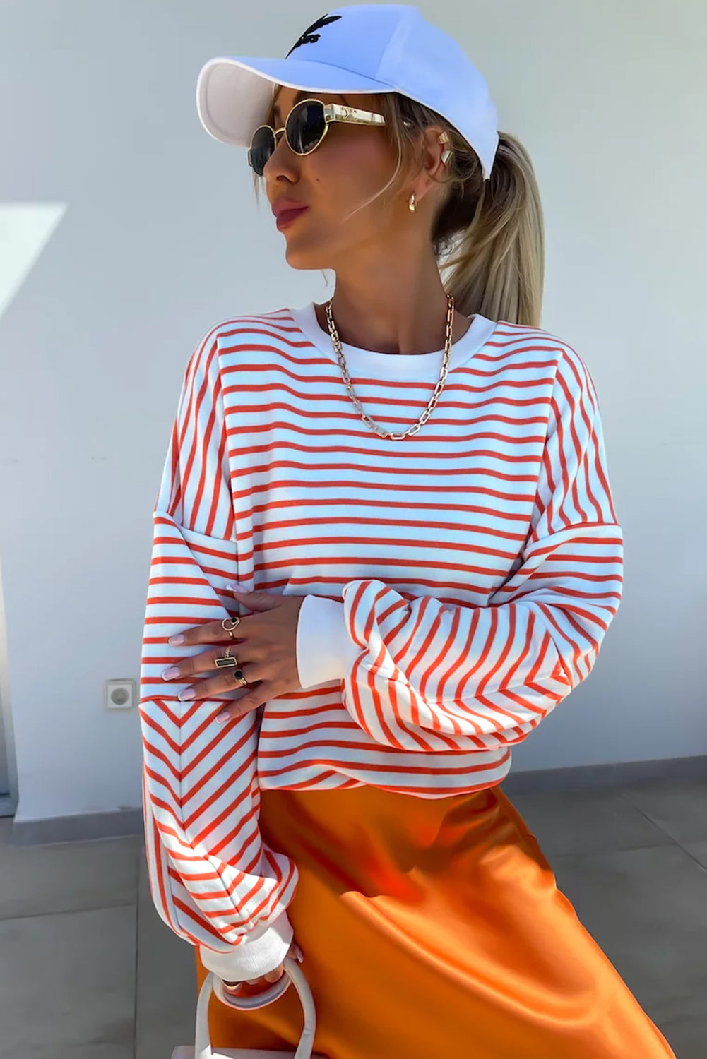 Orange stripe drop shoulder crew neck sweatshirt by ModestAndDevoted, loose fit, made of polyester, cotton, and elastane.