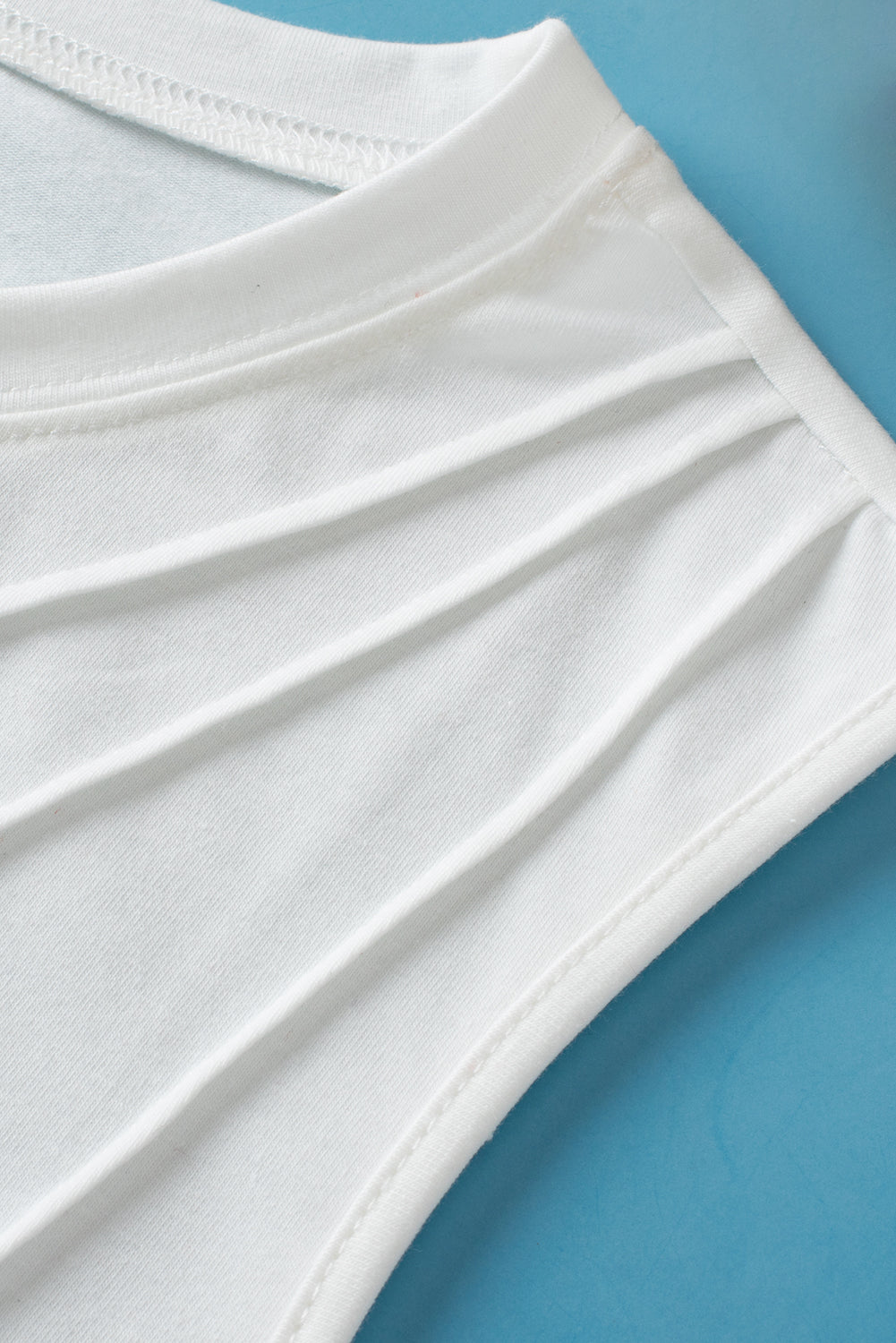 White crew neck pleated tank top by ModestAndDevoted, showcasing lightweight polyester and cotton blend fabric with pleated design.