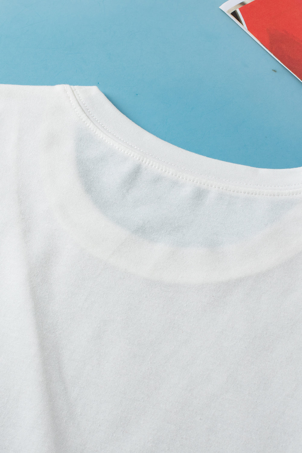 White crew neck pleated tank top from ModestAndDevoted, made of polyester, cotton, and elastane, displayed on a hanger.