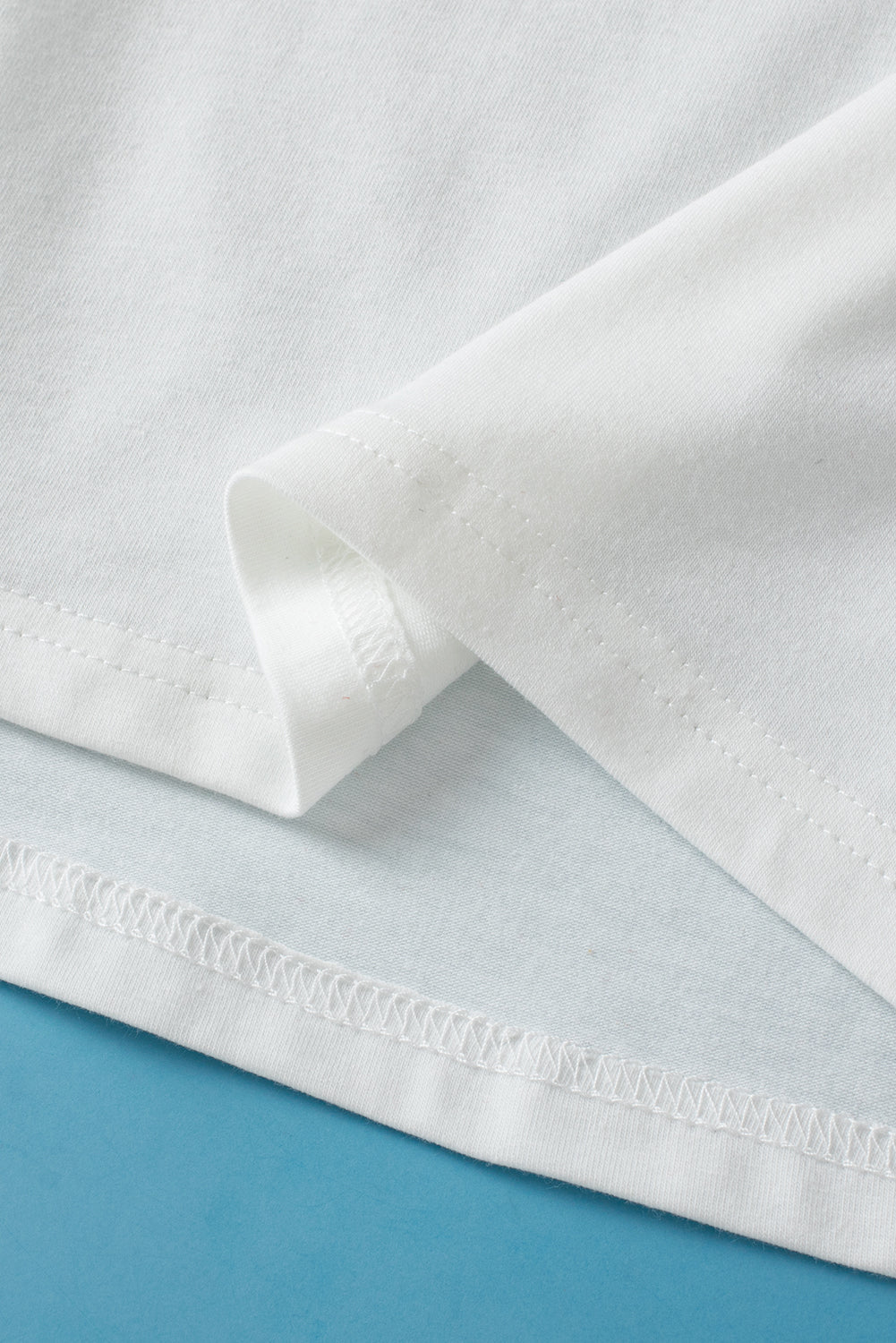 White crew neck pleated tank top from ModestAndDevoted, made of polyester, cotton, and elastane, displayed on a hanger.