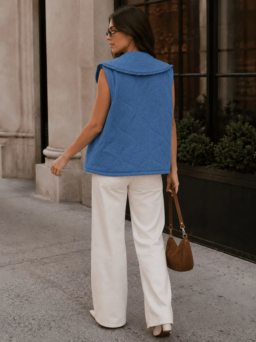 Front view of ModestAndDevoted sleeveless denim vest with a front tie, collared design, and sleeveless style.