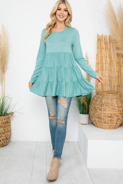 Cream-colored solid long sleeve tiered top by Perfect Peach, featuring a relaxed fit and subtle textured fabric.