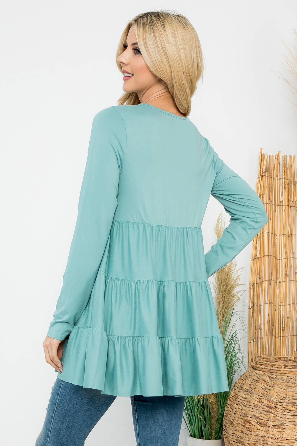 Cream-colored solid long sleeve tiered top by Perfect Peach with a relaxed fit and subtle texture.