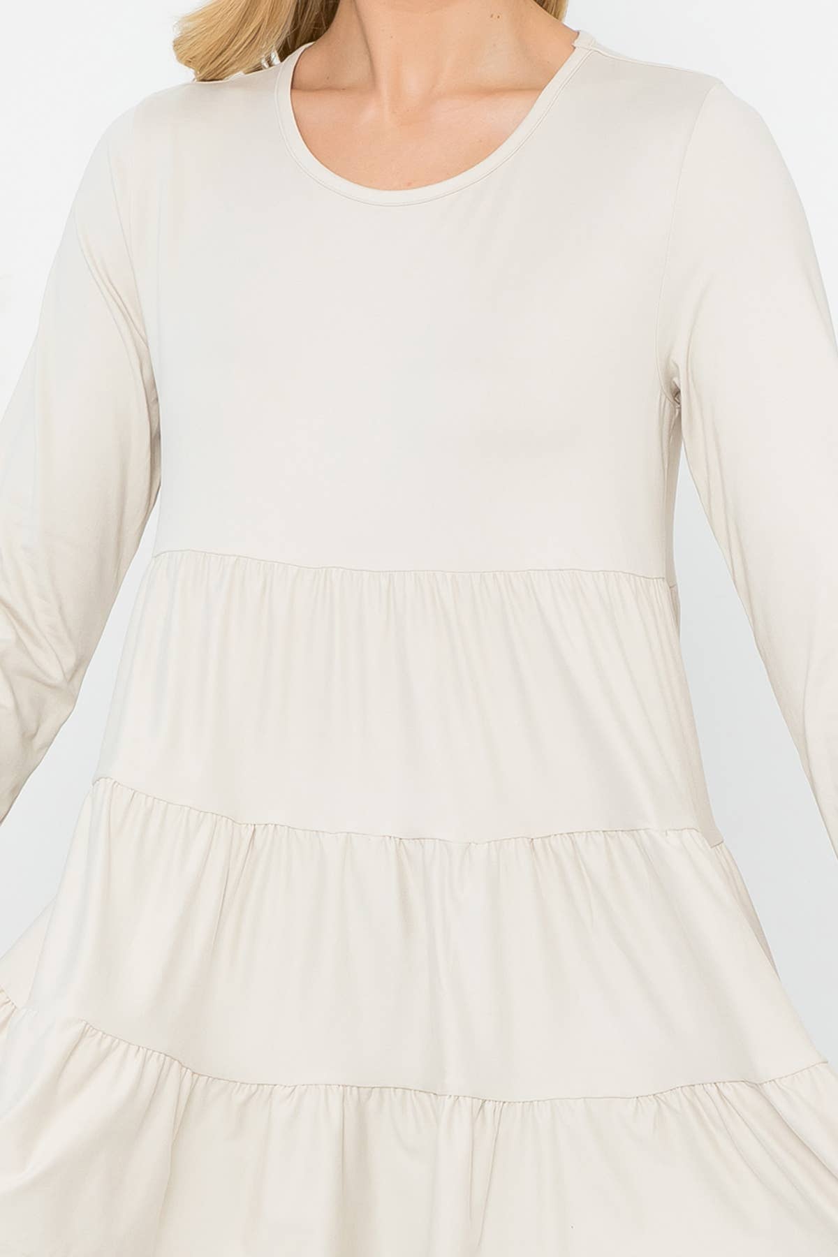 Cream-colored solid long sleeve tiered top by Perfect Peach, featuring a relaxed fit and feminine design.