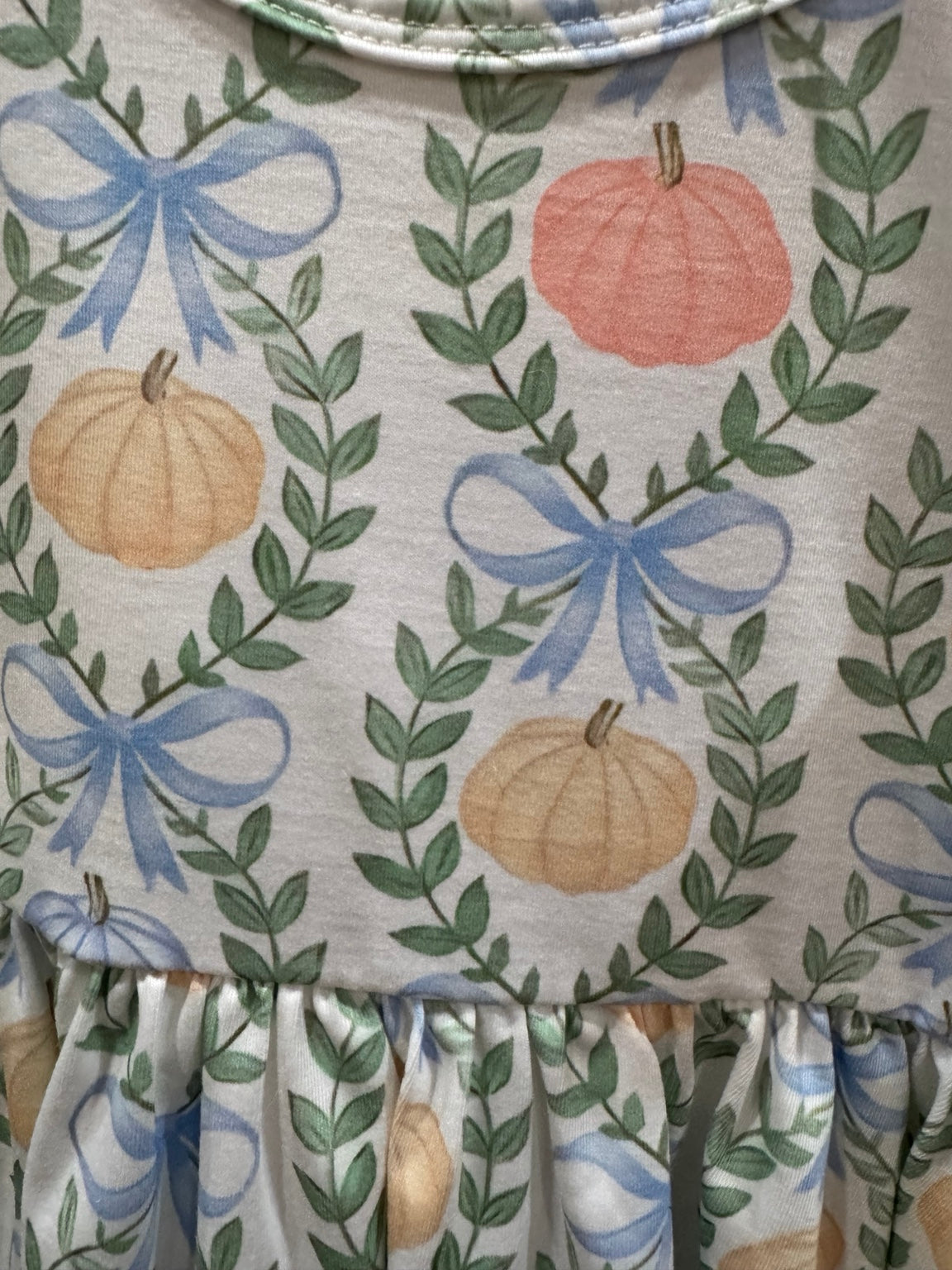 Pastel pumpkin and blue bow print detail