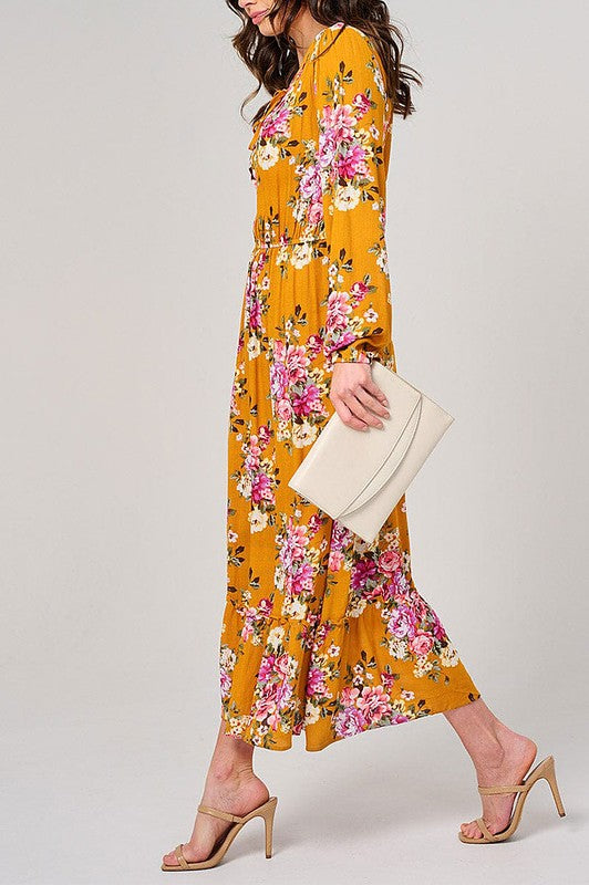 Long sleeve floral maxi dress with elastic waist in mustard color by Rousseau, featuring a flowing, elegant design.