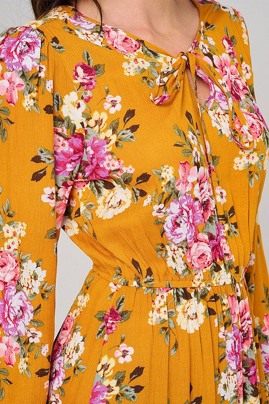 Rousseau long sleeve floral maxi dress with elastic waist in mustard color, flowing fabric, and elegant design.