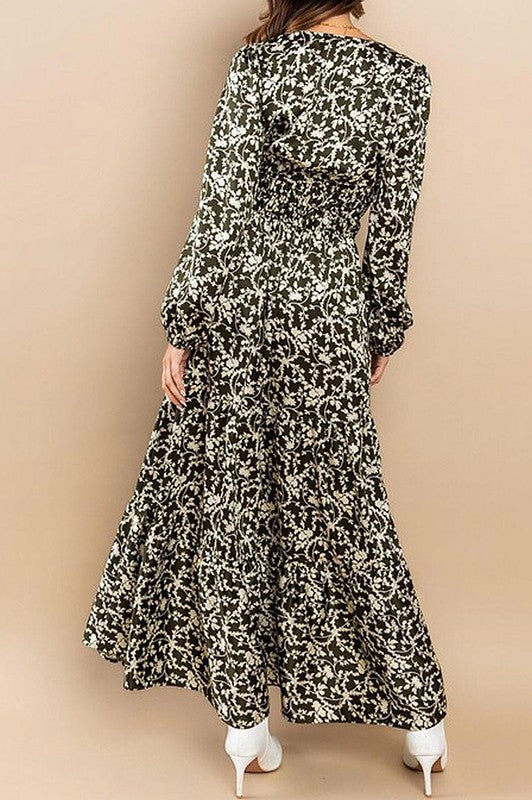 Olive satin tiered maxi dress with long sleeves and elastic waist by Rousseau, shown hanging on a white background.