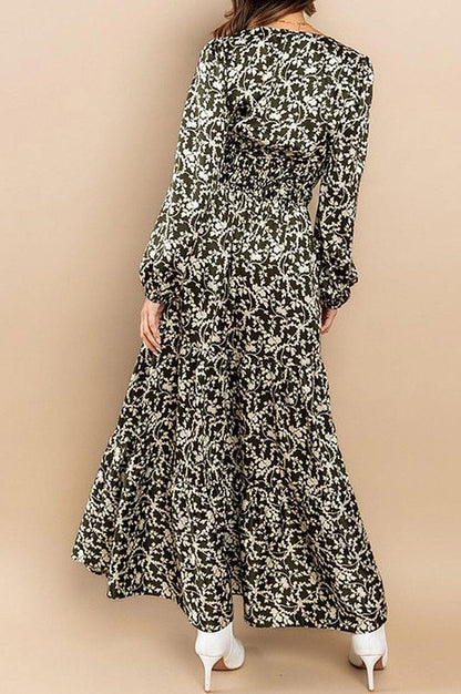 Olive satin tiered maxi dress with long sleeves and elastic waist by Rousseau, shown hanging on a white background.