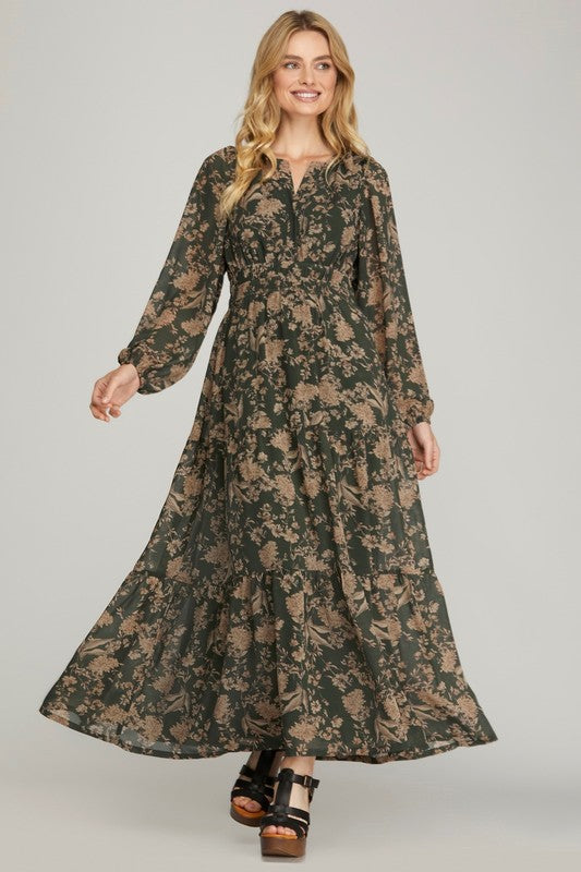 Black plus-sized printed tiered maxi dress from She+Sky, flowing fabric with layered design and long sleeves.