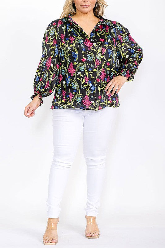 Vibrant floral long sleeve blouse with ruffle V-neck from Sugarless, featuring colorful patterns and a relaxed fit.