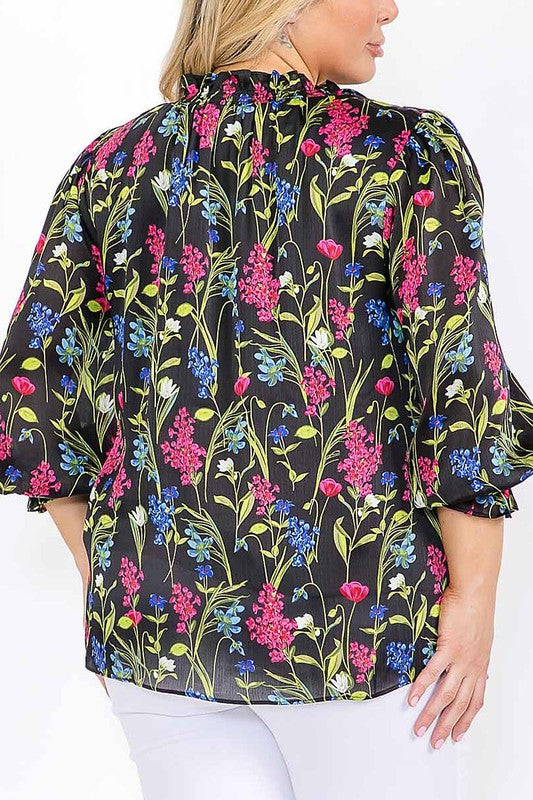 Long sleeve floral blouse with ruffle V-neck in vibrant colors, by Sugarless, featuring a feminine, flowy design.