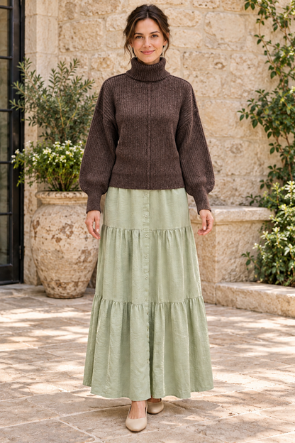 Woman wearing Timing deep brown heathered turtleneck sweater with sage maxi skirt