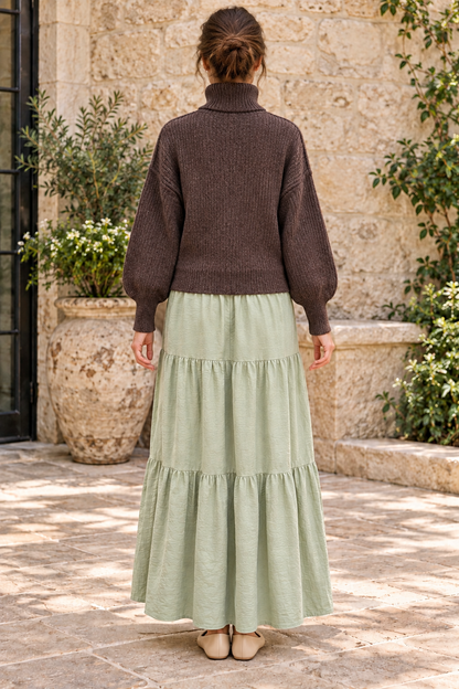 Timing deep brown heathered turtleneck sweater worn with sage maxi skirt, back view