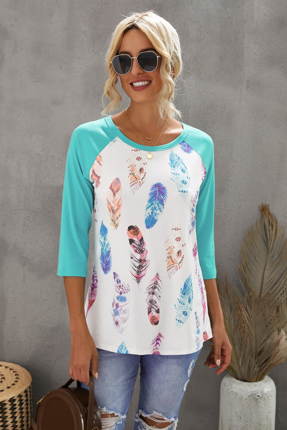 Small feather print 3/4 sleeve raglan shirt, lightweight and casual top with comfortable sleeve length and subtle design.