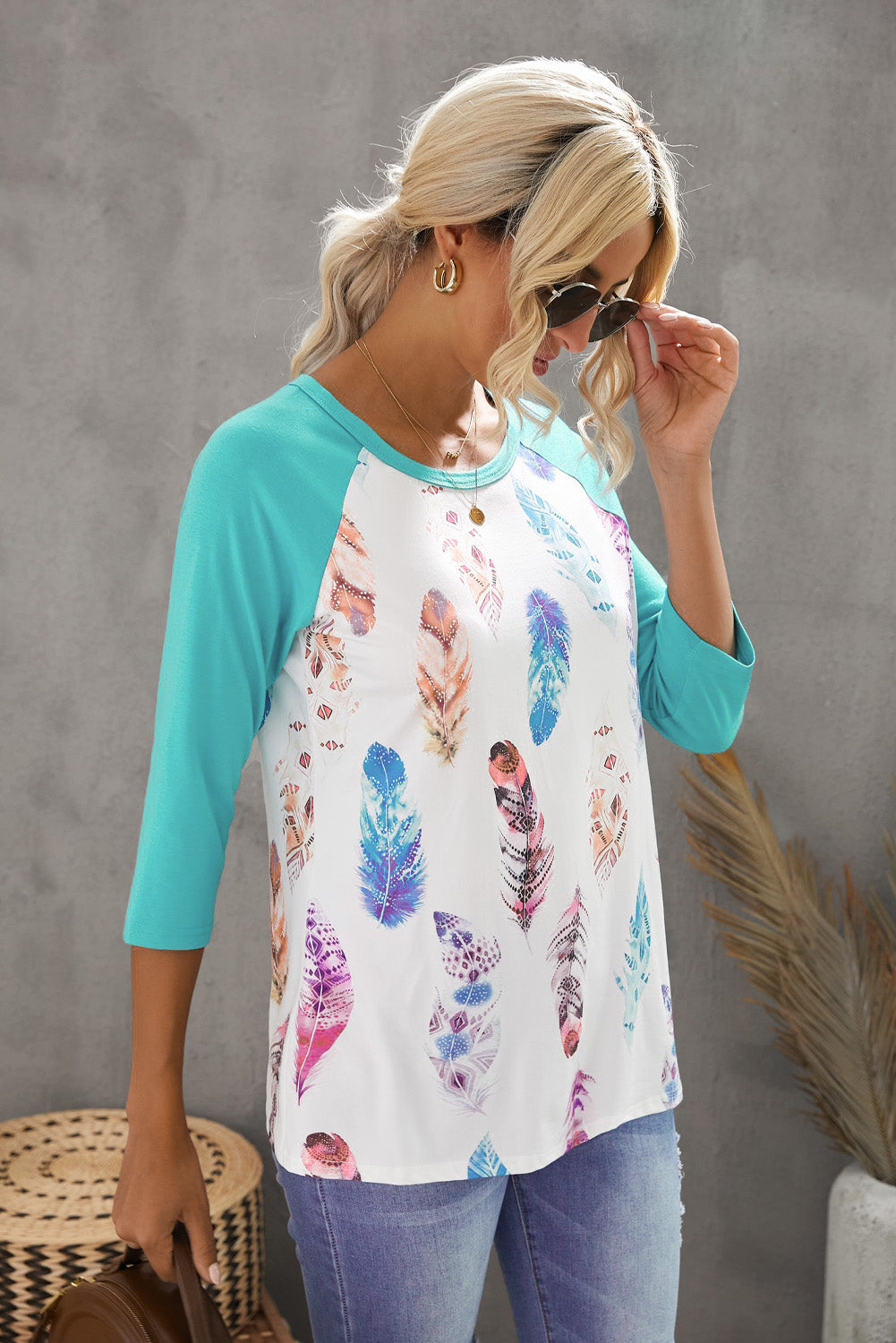 Feather print 3/4 raglan sleeve top featuring a soft fabric and casual fit, perfect for everyday wear.