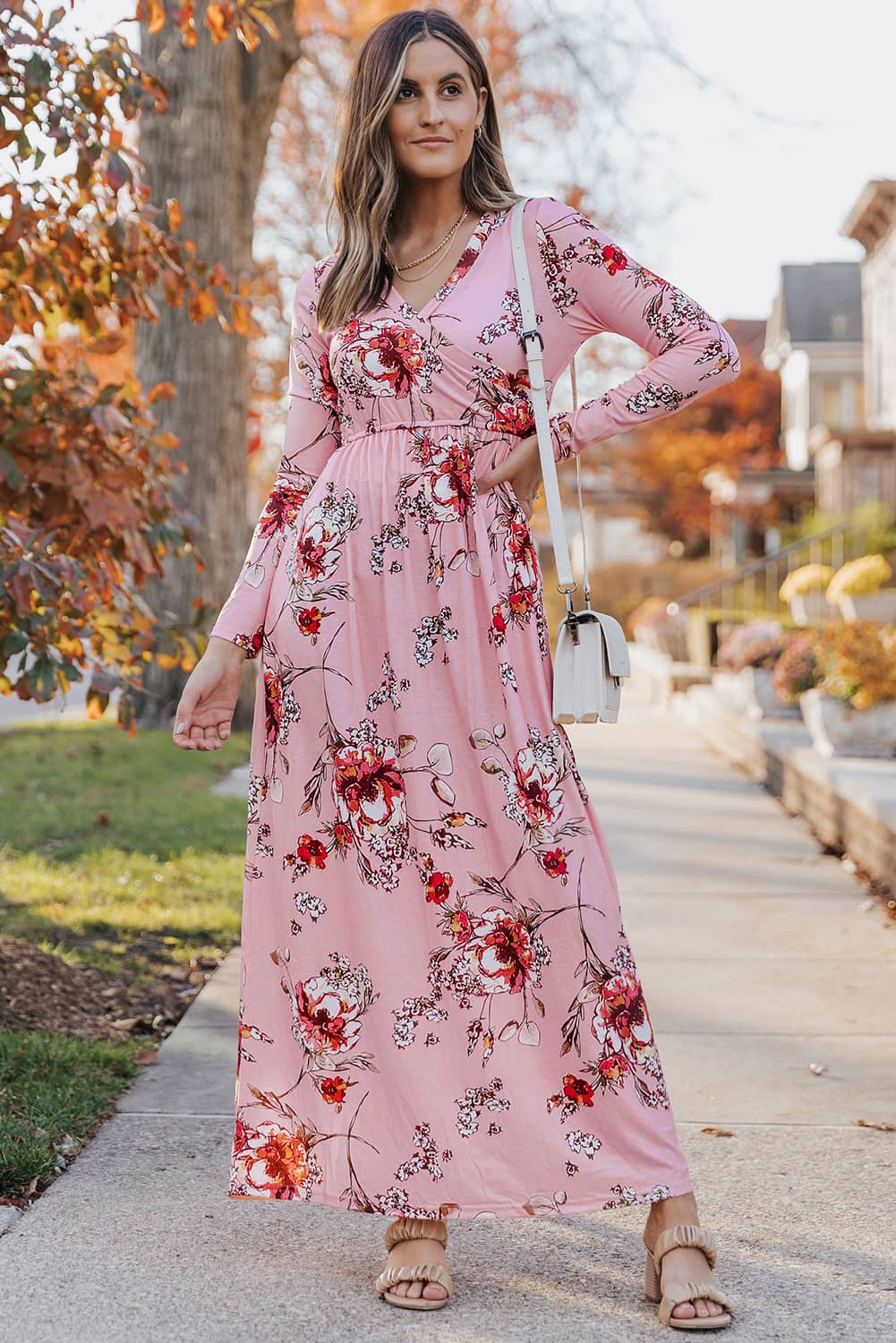 Pink faux wrap empire maxi dress with flowing fabric and V-neckline, perfect for elegant summer occasions.