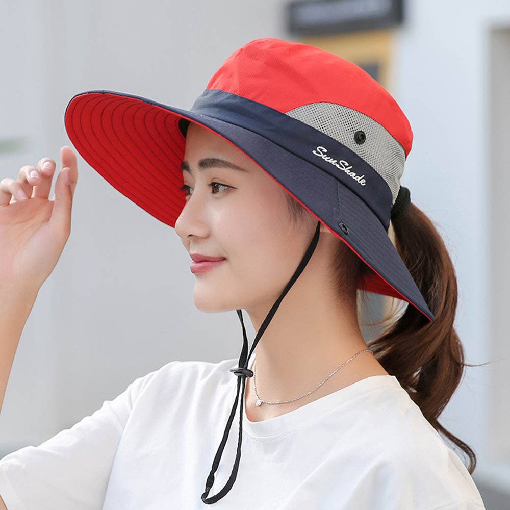 Pink women's UV protection sun hat with a foldable wide brim and ponytail opening, by Wholesalesir.