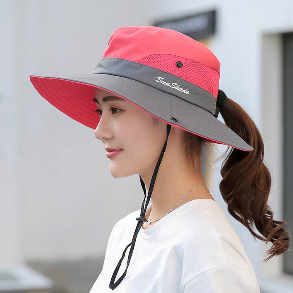 Pink women's UV protection hat with a wide brim and foldable design, featuring a ponytail opening, by Wholesalesir.