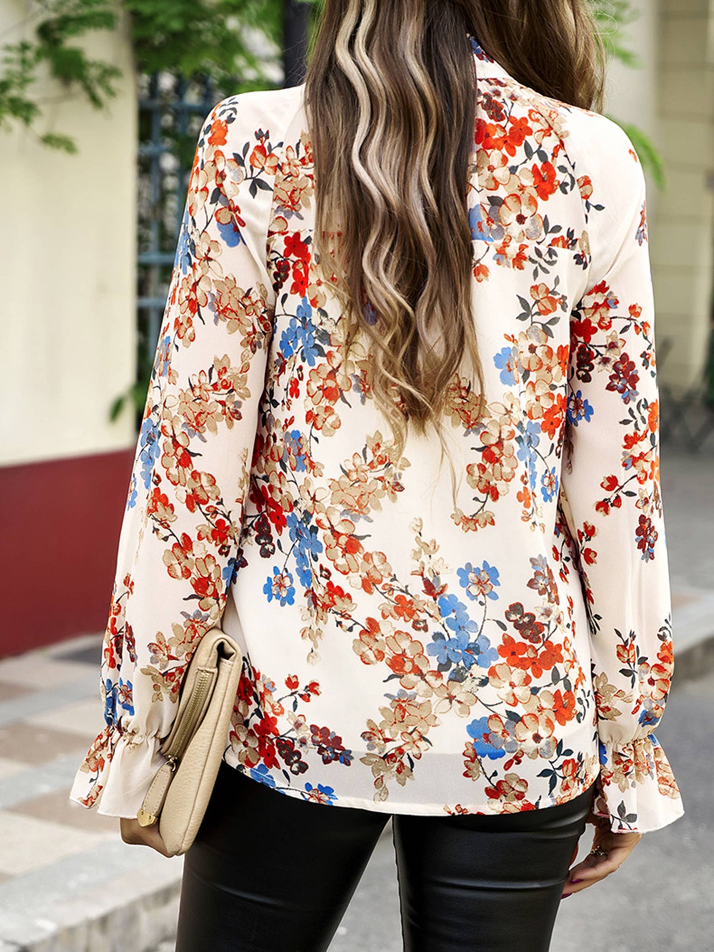 Elegant floral blue long-sleeved shirt for women by wholesalesir, featuring a colorful floral pattern and classic long sleeve design.